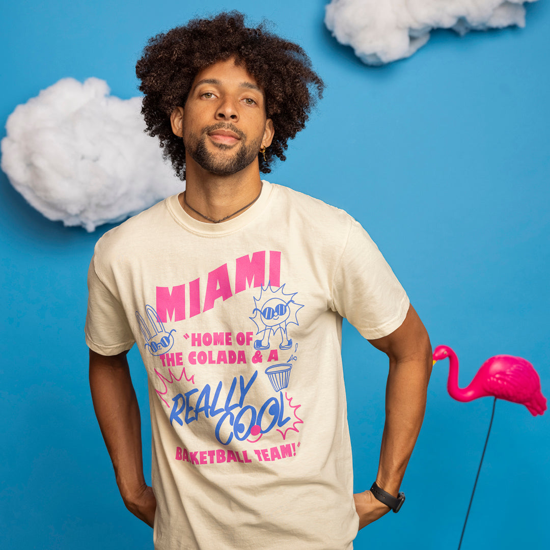 Beige Court Culture unisex tee with pink and blue Miami HEAT graphic and playful text design. - Court Culture Postcard Unisex Tee