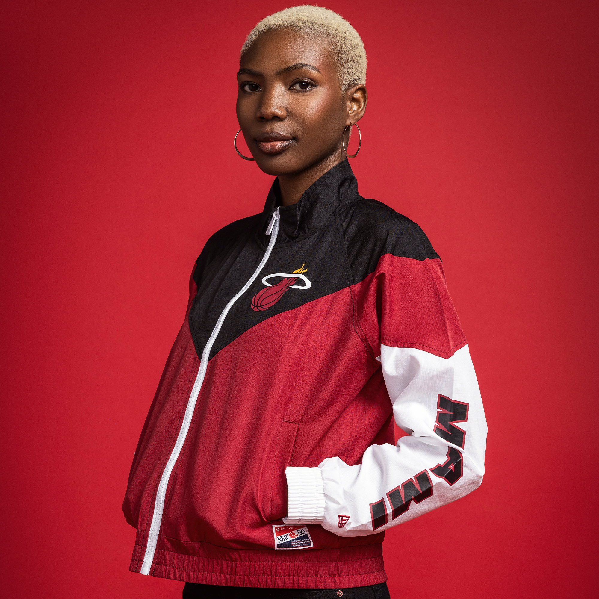 Women's Miami HEAT full-zip windbreaker in red, black, and white with logo on chest and team name on sleeve.