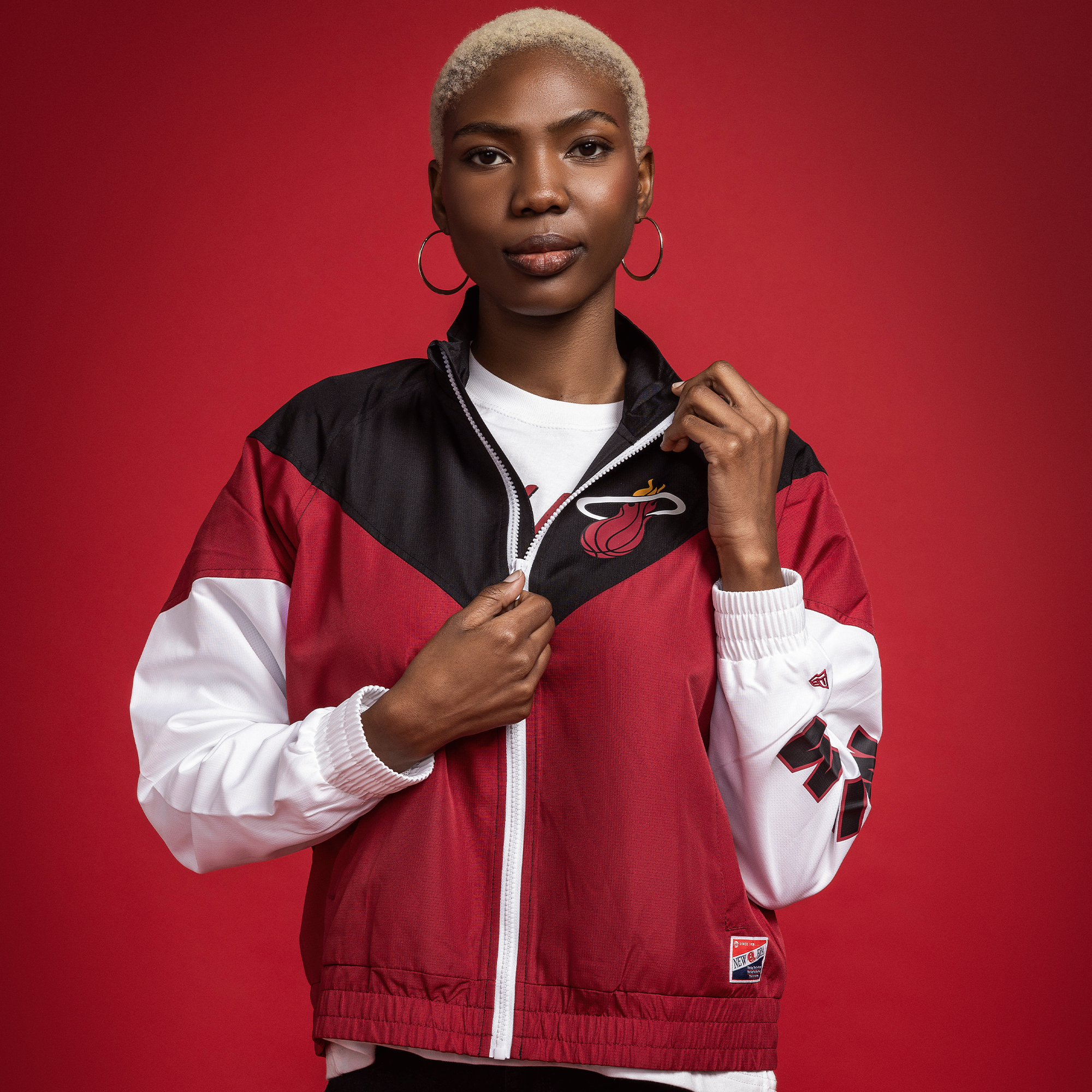 Women's Miami HEAT full-zip windbreaker with black, red, and white color blocks and team logo on chest and sleeve.