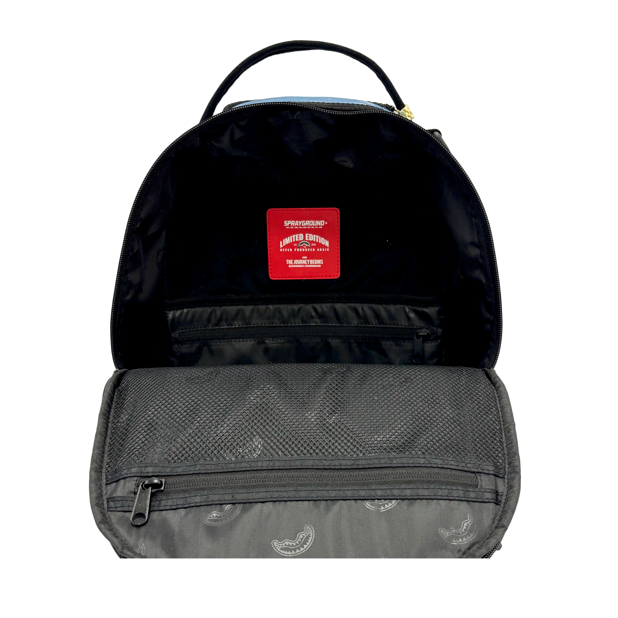 Open the Court Culture x Sprayground Miami HEAT Tie-Dye Jaw Backpack to reveal its interior, featuring a red Limited Edition label, a mesh pocket, and an inner flap adorned with a pattern of small paisley designs. An embroidered Sprayground logo adds a subtle touch of style to this exclusive piece.
