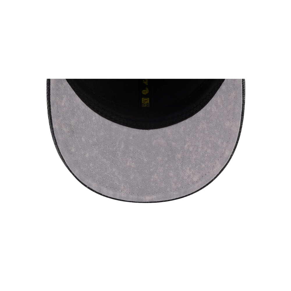 Top-down view of the underside of a curved visor on the New Era Miami HEAT 5950 Logo Fitted Hat, featuring a light grey textured surface, black edge, and part of the black inner lining on this cotton fitted cap by New Era.