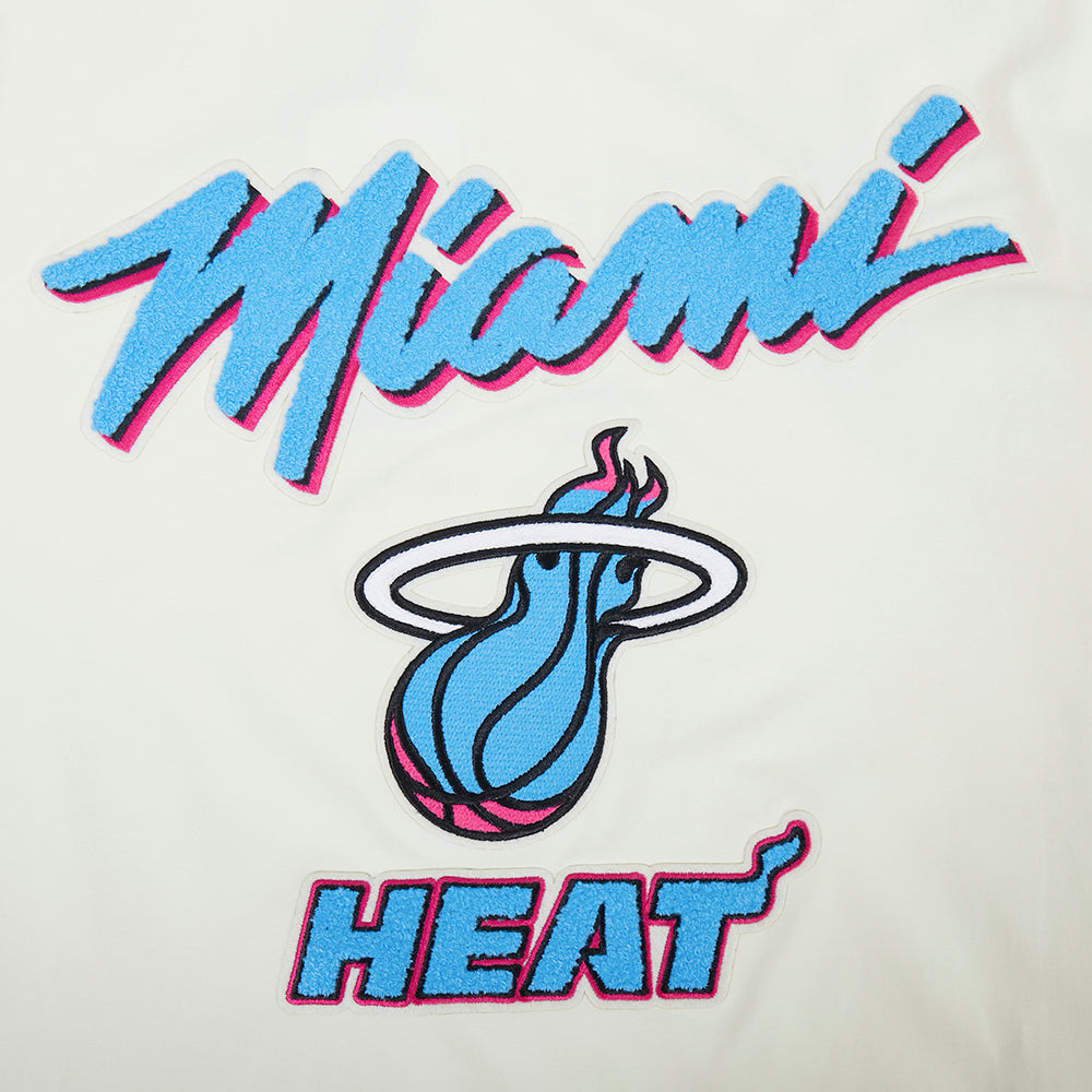 The Pro Standard Miami HEAT Original Vice Nights Logo Tee features a blue and pink script Miami, stylized blue flaming basketball with halo, and bold HEAT lettering on white cotton-spandex for a comfortable, machine-washable standard fit.