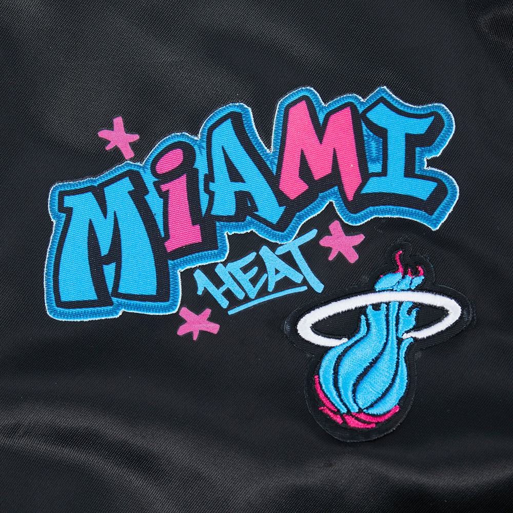 The Pro Standard Miami HEAT Original Vice Nights Youth Satin Jacket features an embroidered Miami Heat logo, bold blue and pink graffiti-style 