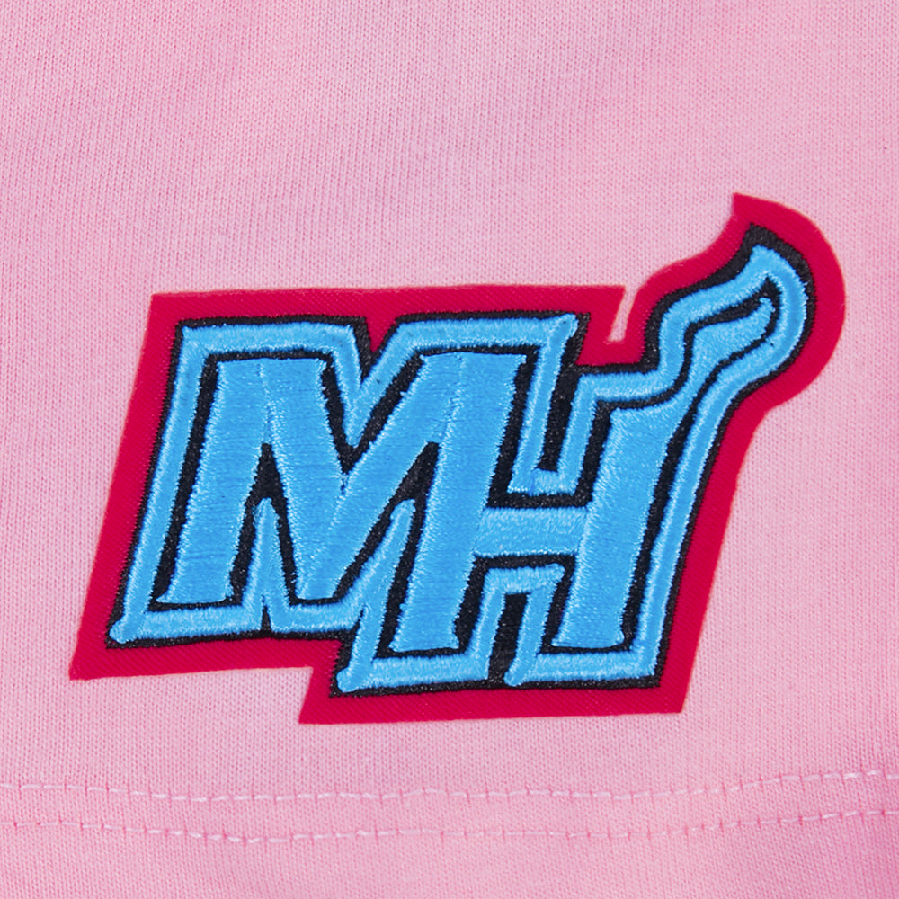 The Pro Standard Miami HEAT Original Vice Nights Girls Graffiti Boxy Tee features a blue and white embroidered MH logo with a red border and flame on the H, sewn onto pink cotton for a relaxed fit—both stylish and machine washable.