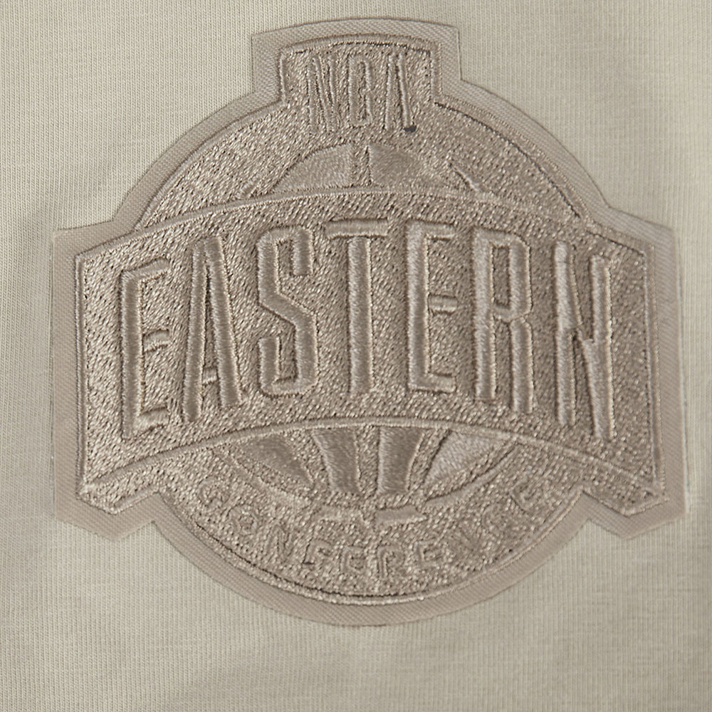 The Pro Standard Miami HEAT Original Vice Nights Beige Women's Hoodie features bold EASTERN embroidery with a circular background on light cotton-polyester fabric and smaller text above and below. Wash with like colors to maintain its look.