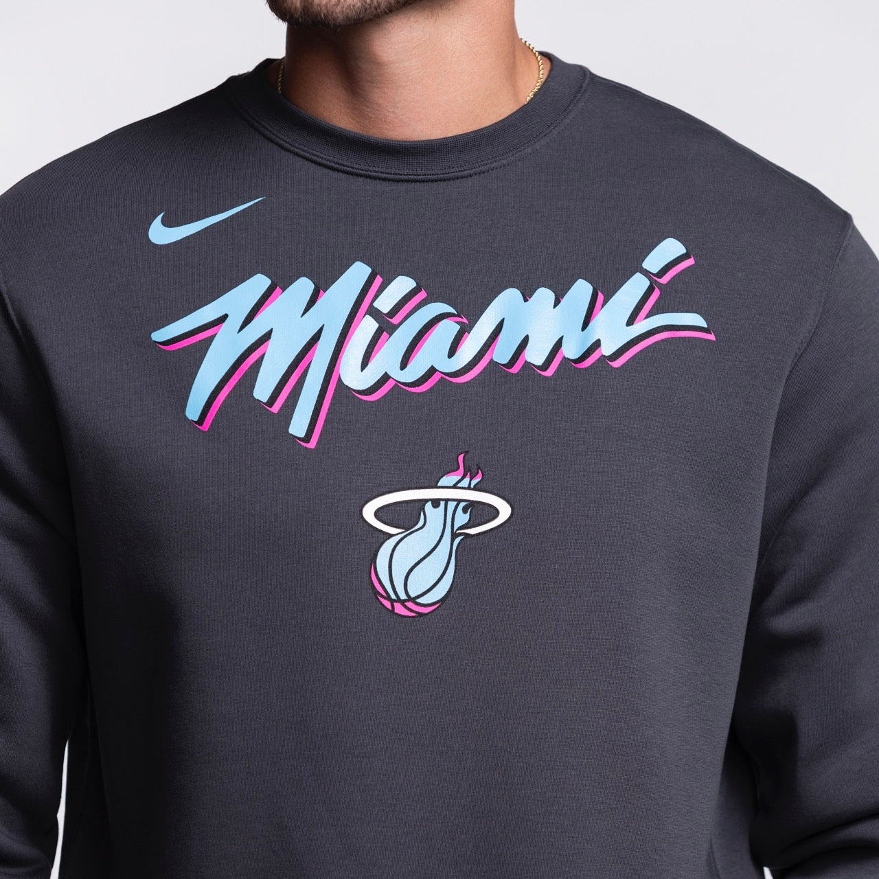 Wearing the Nike Miami HEAT Original Vice Nights Crewneck, a standard fit cotton-polyester shirt, features 
