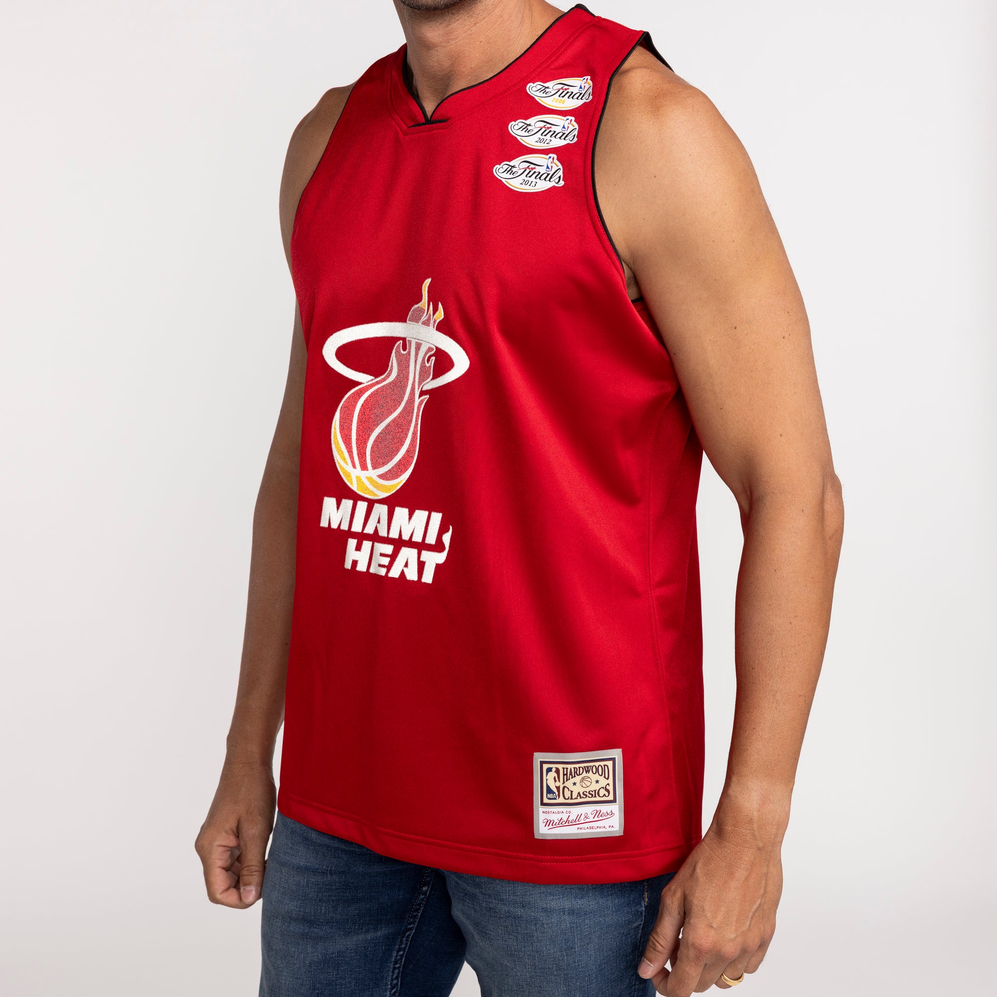 Red Miami HEAT fashion jersey with white team logo and black collar trim, sleeveless design. - UNKNWN X Mitchell and Ness X Miami HEAT My Towns Fashion Jersey