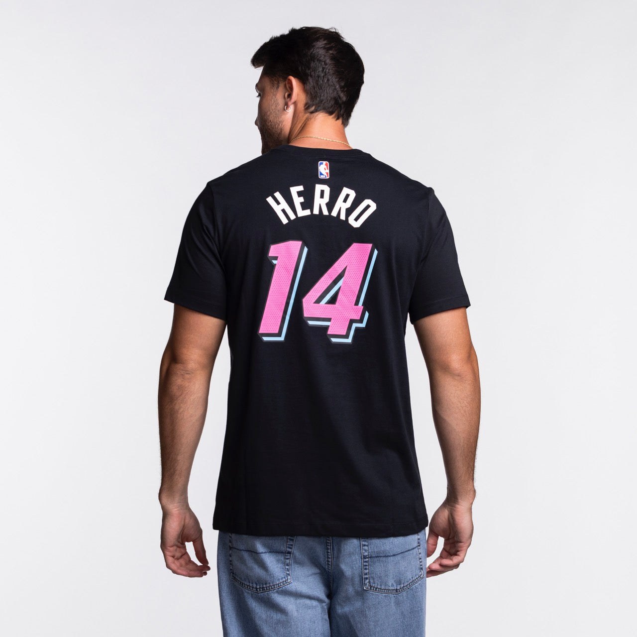A man faces away, wearing the Nike Tyler Herro Original Vice Nights Name & Number Tee in black cotton, featuring 