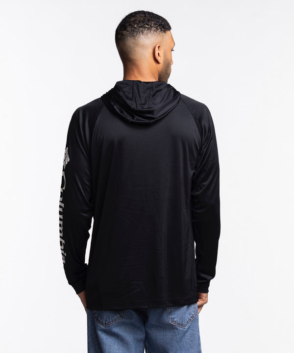 A man stands against a white background wearing the Columbia Miami HEAT Original Vice Nights Long Sleeve Hoodie Tee by Columbia Outdoor in black, featuring colorful 