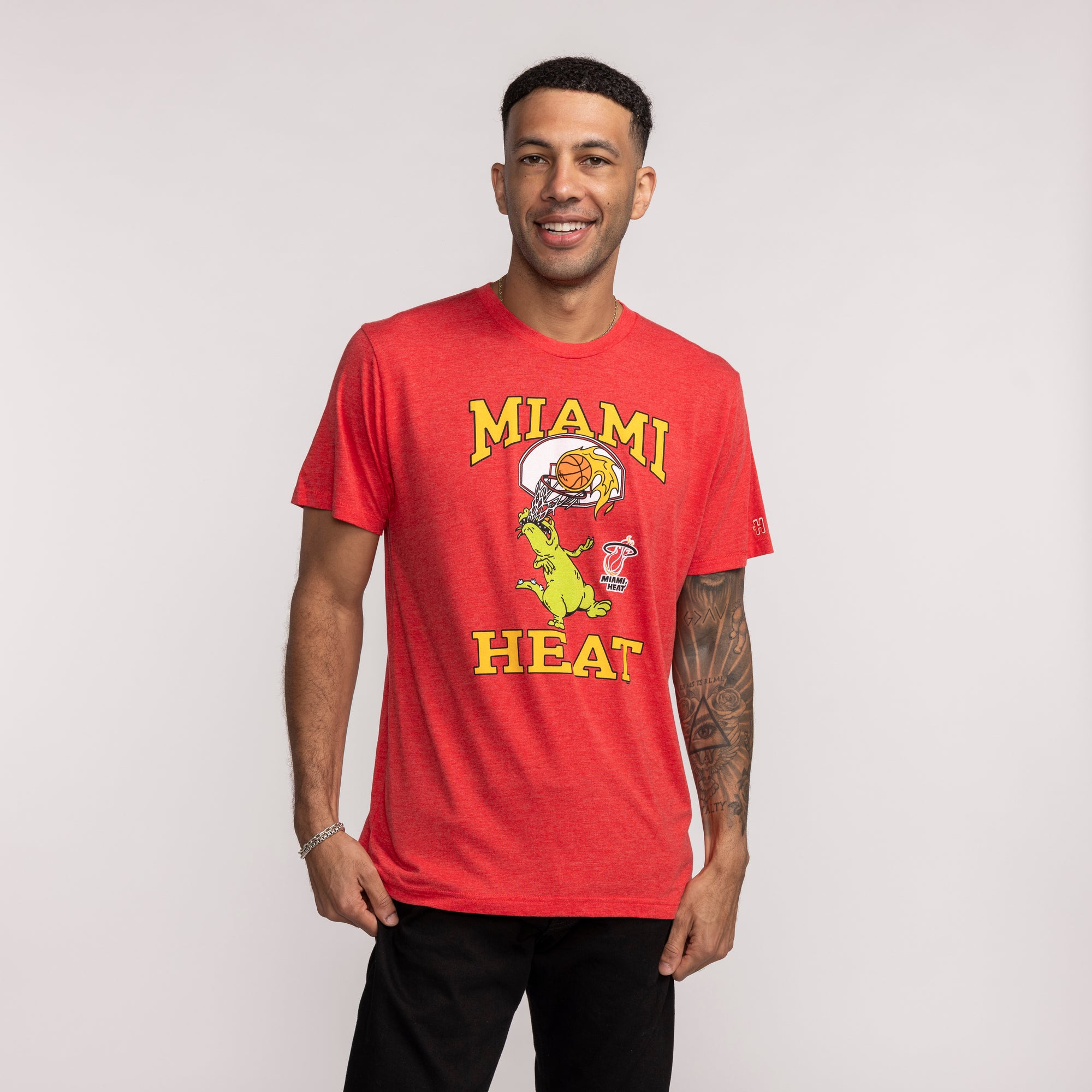 Red short-sleeve tee with yellow Miami HEAT text and cartoon reptile graphic on front. - Homage Miami HEAT Reptar Red Tee