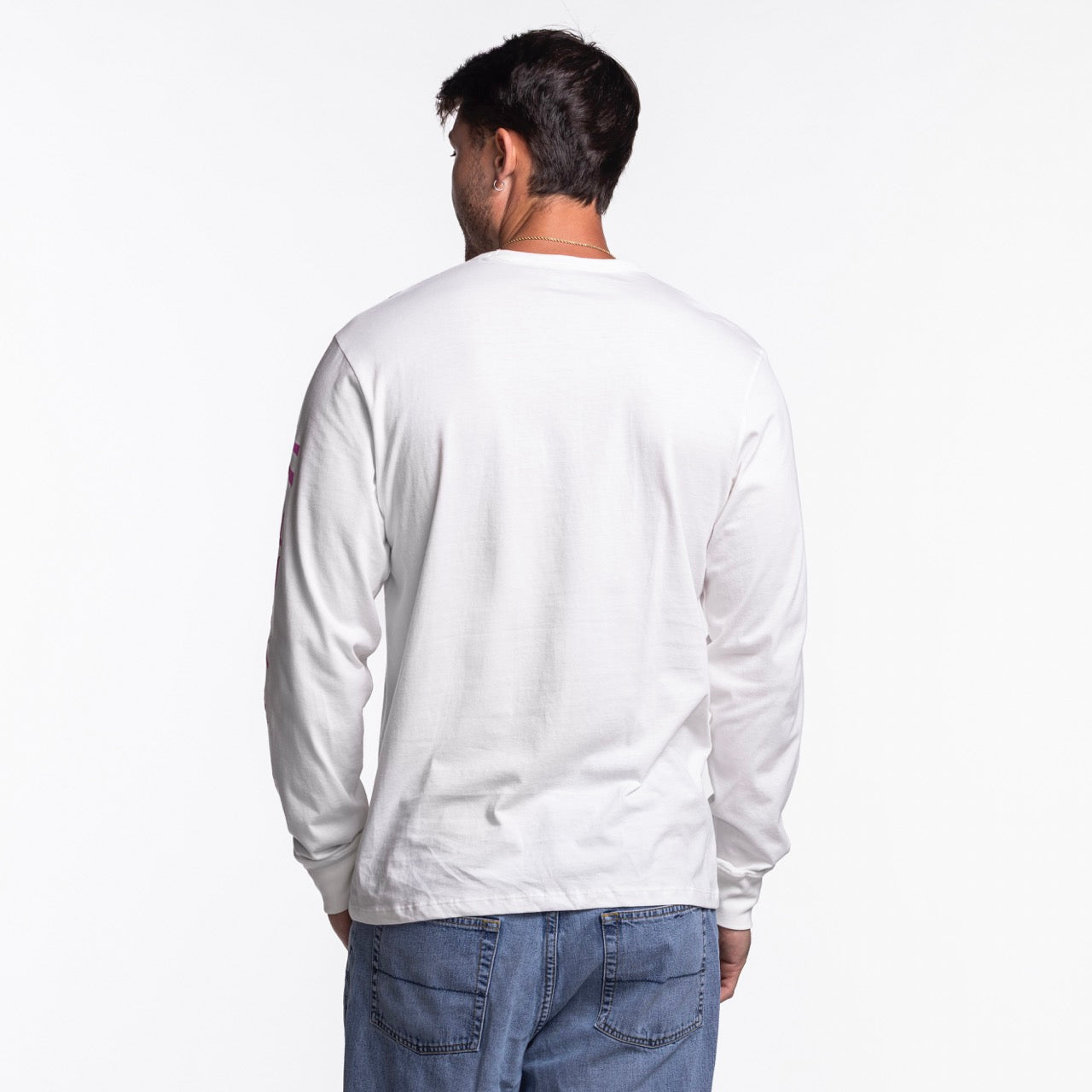 A man faces away from the camera wearing a '47 Brand Miami HEAT Original Vice Nights White Long Sleeve Tee and blue jeans against a white background. The tee is standard fit, made of cotton, and machine washable for easy care.