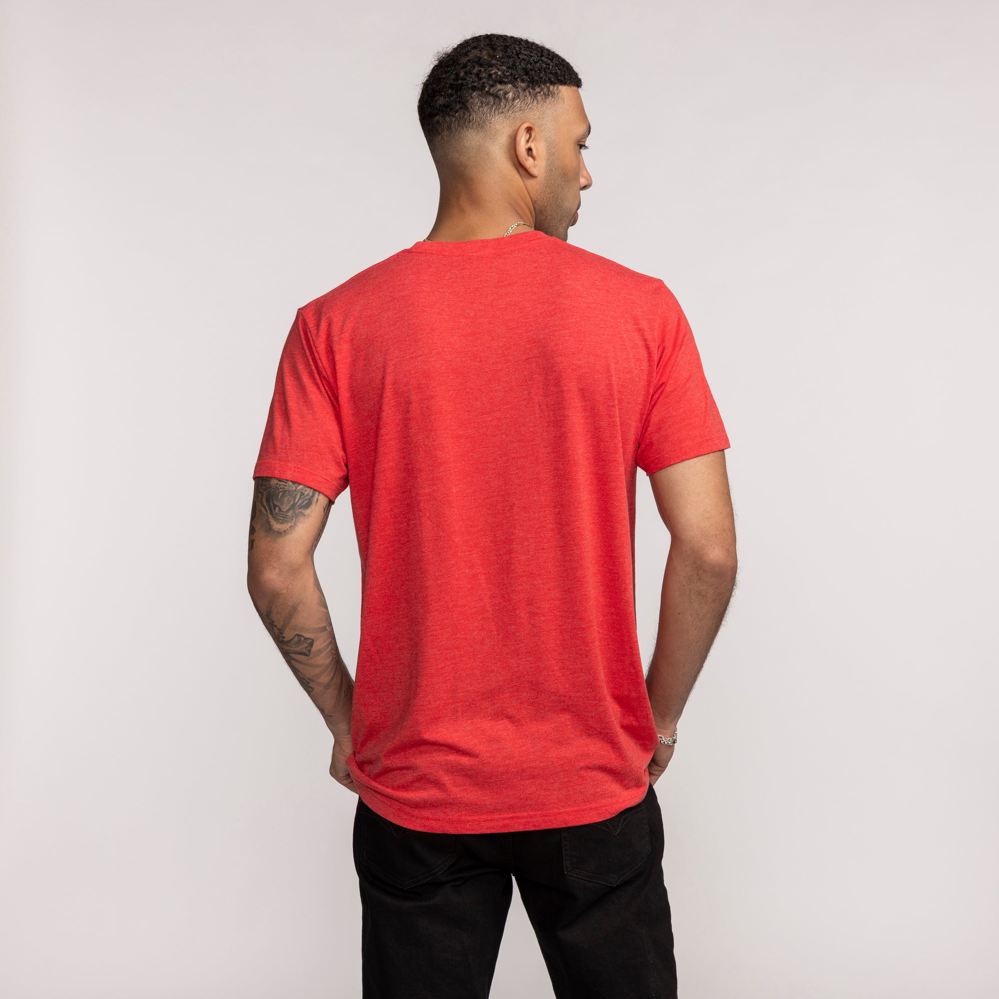 Red short-sleeve tee with Miami HEAT-inspired design, shown from back on male model. - Homage Miami HEAT Reptar Red Tee