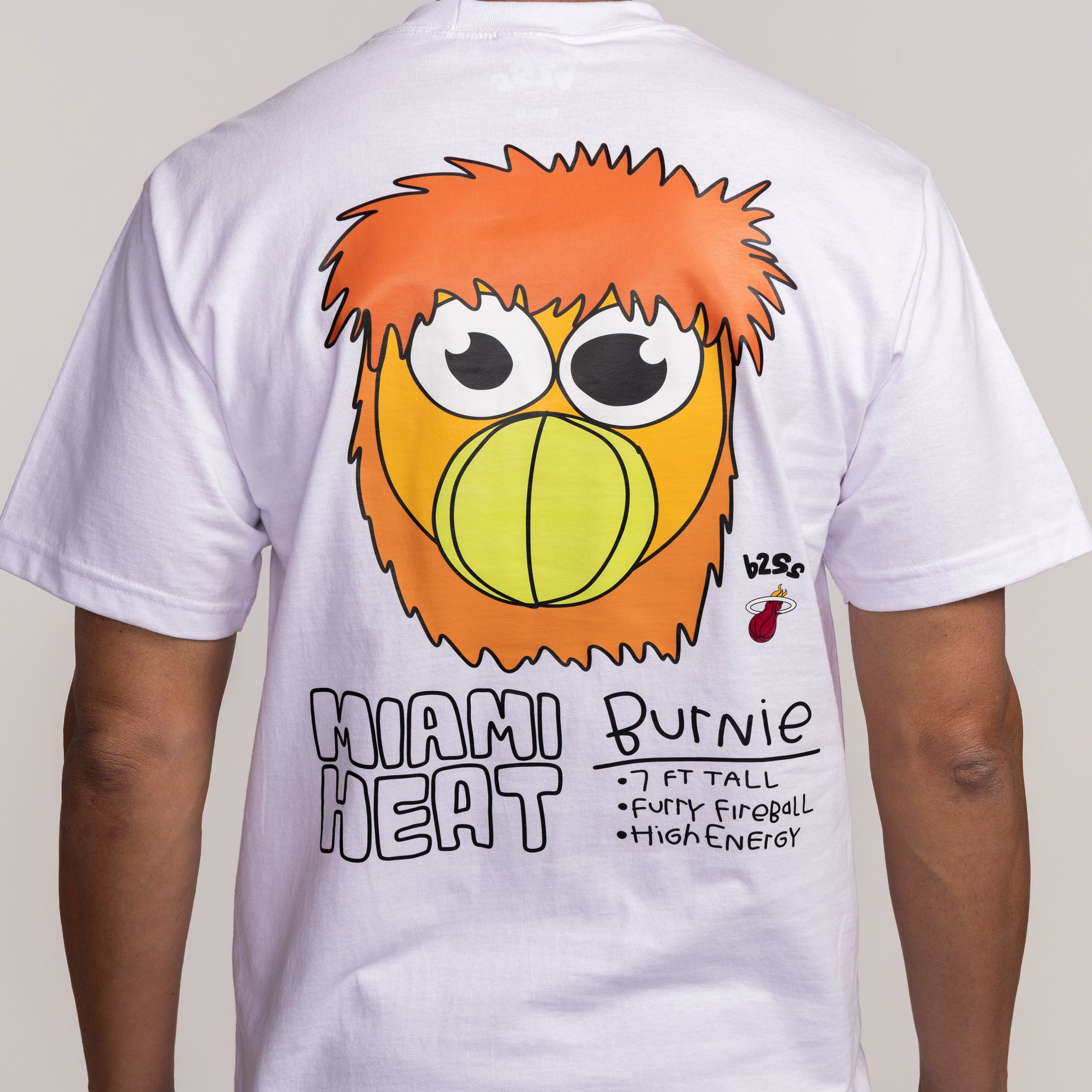 White short-sleeve Miami HEAT tee with colorful cartoon Burnie mascot and bold graphic text on back. - B2SS Miami HEAT Get Loud Tee