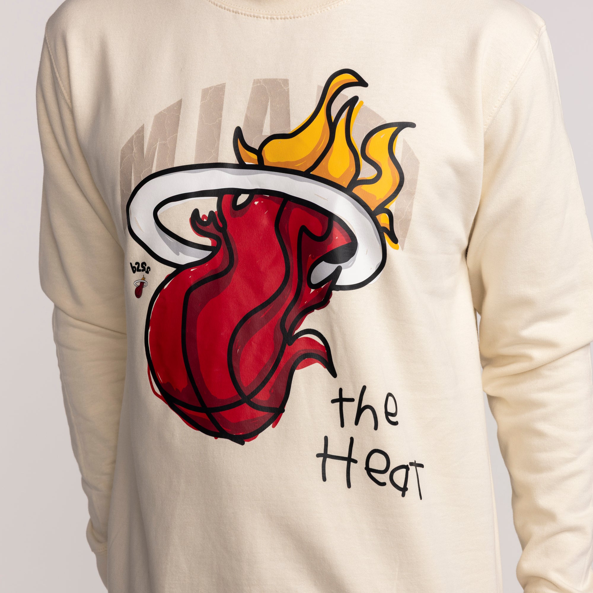 Cream long-sleeve crewneck featuring vintage Miami HEAT flaming basketball graphic and text. - B2SS Miami HEAT Cream Vintage Crewneck