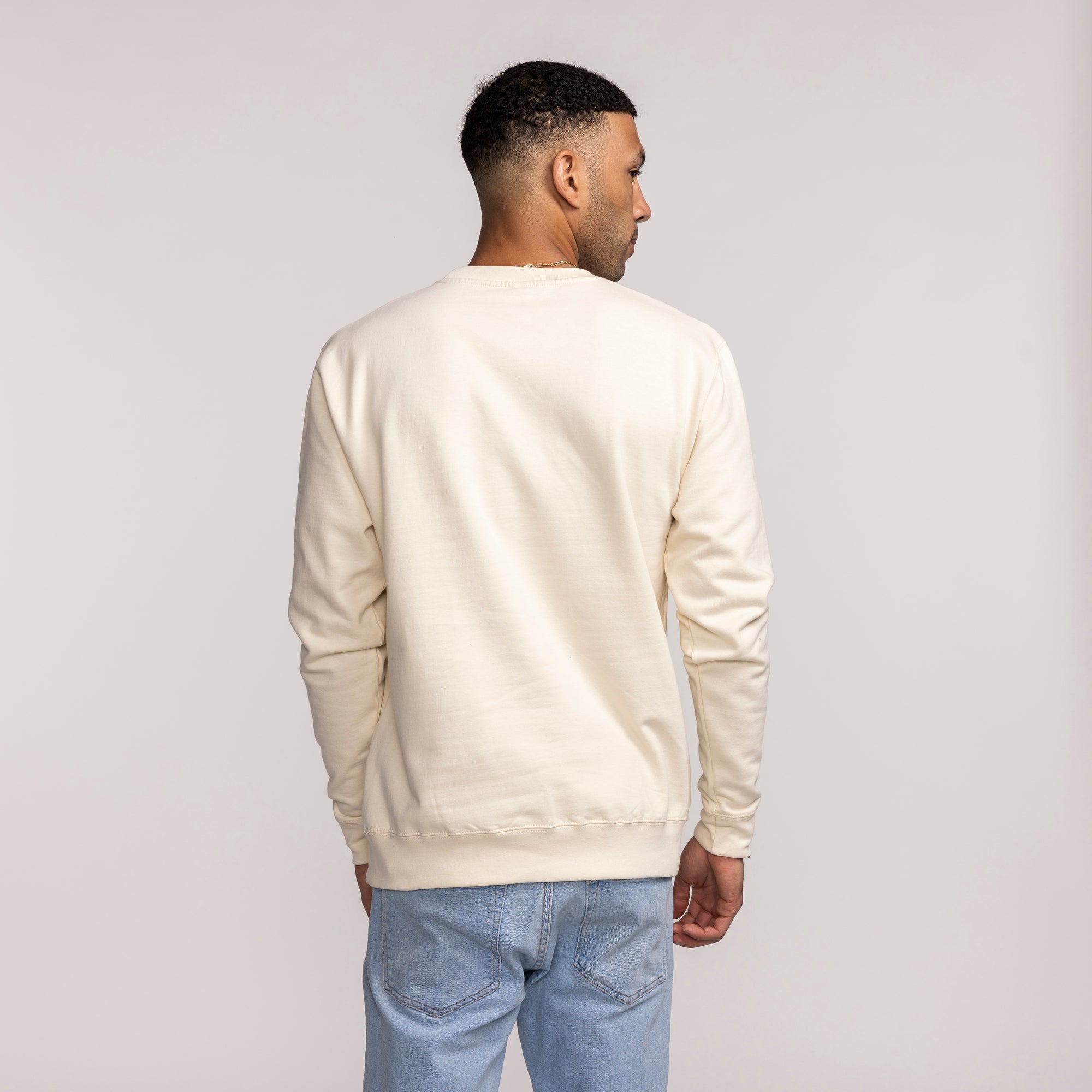 Cream long-sleeve vintage crewneck sweatshirt with Miami HEAT logo on back, worn by male model. - B2SS Miami HEAT Cream Vintage Crewneck