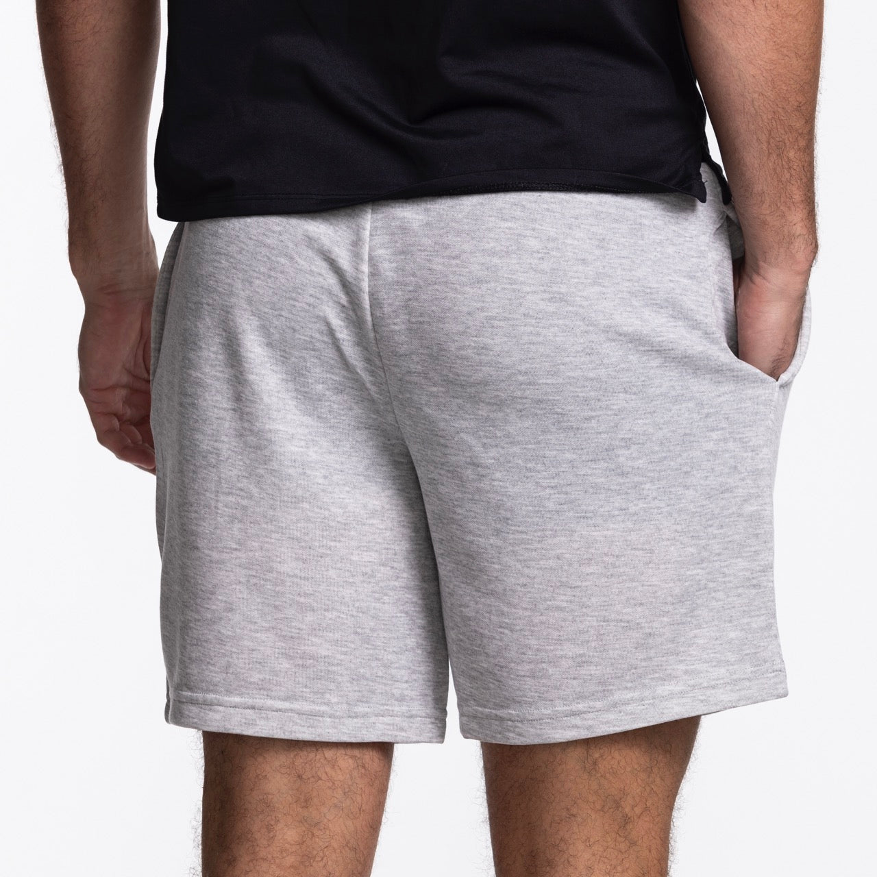 A person stands with their hand in their pocket, wearing Concepts Sports Miami HEAT Original Vice Nights Shorts, shown from the back against a plain white background.