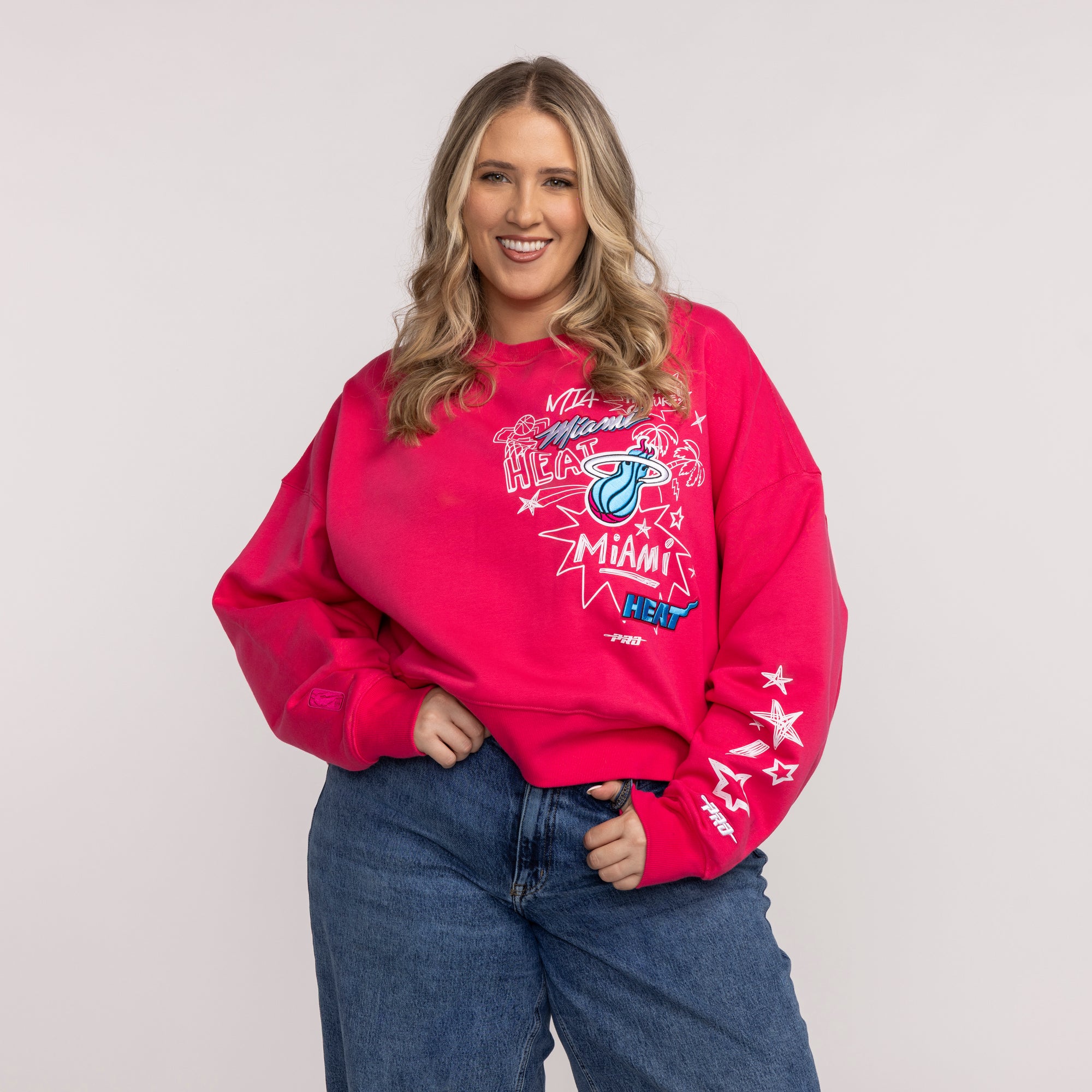 Vice pink Miami HEAT crewneck sweatshirt with colorful graphic and white stars on sleeve. - Pro Standard Miami HEAT Original Vice Pink Women's Crewneck