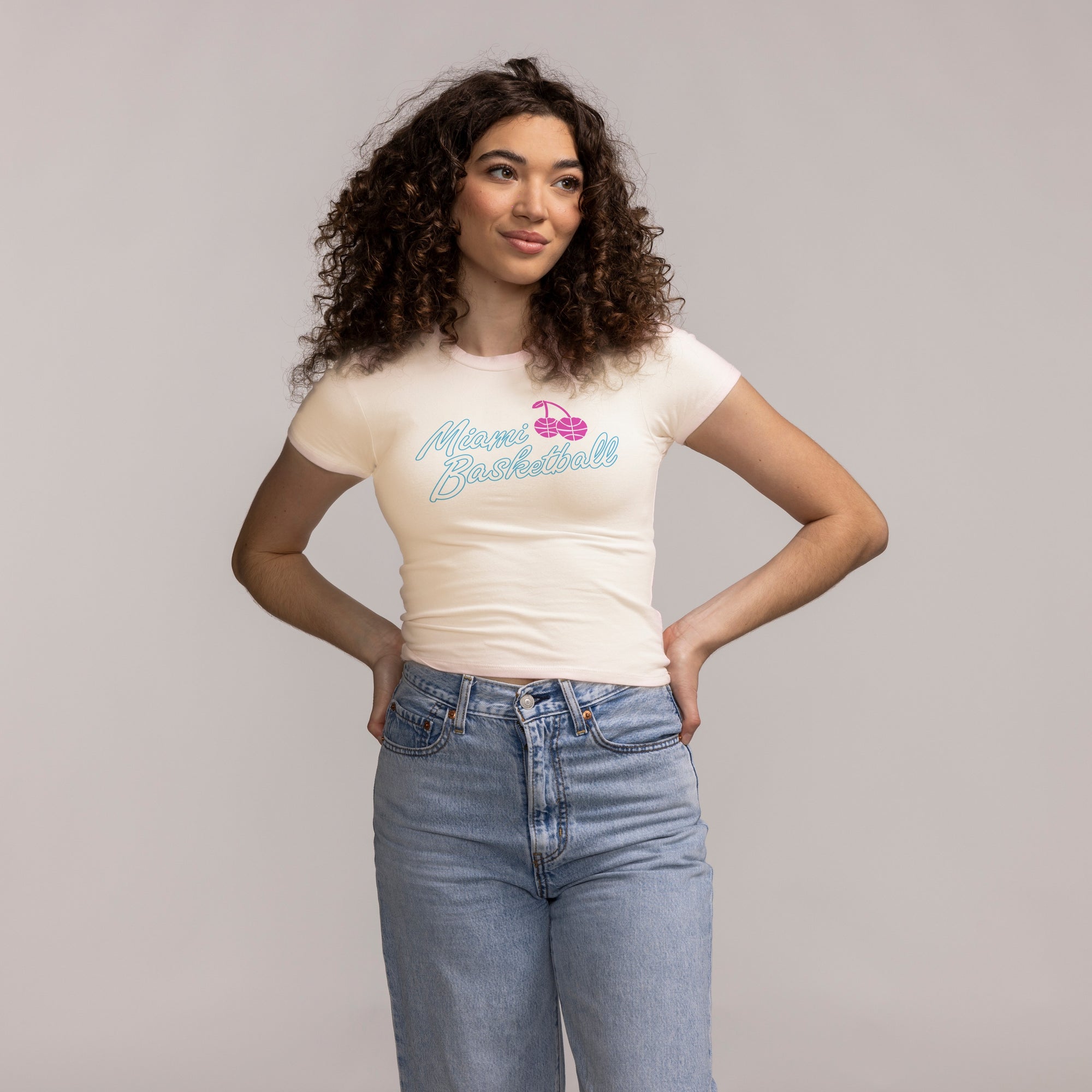 A person with curly brown hair wearing a white Court Culture Original Vice Nights 