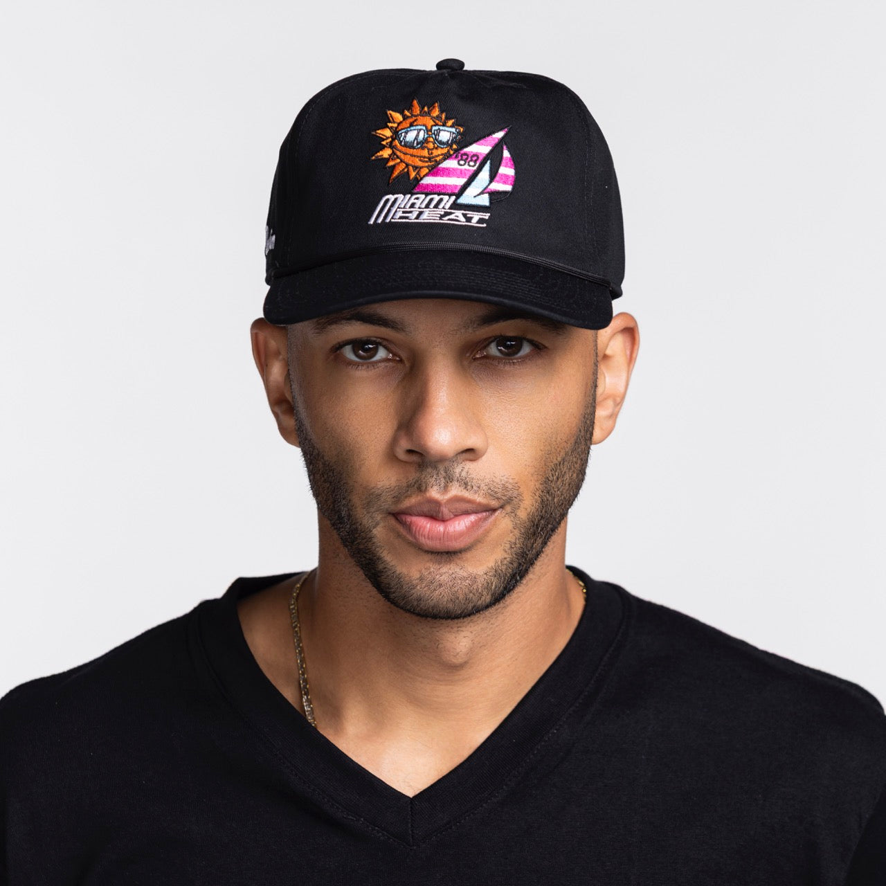 A man in a black V-neck shirt and a Court Culture Miami HEAT x Duvin Original Vice Nights 