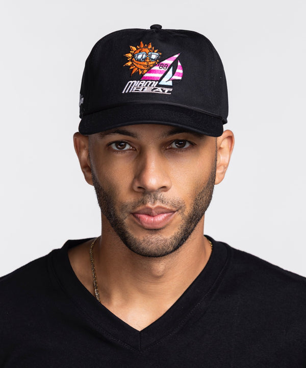 A man in a black V-neck shirt and a Court Culture Miami HEAT x Duvin Original Vice Nights 