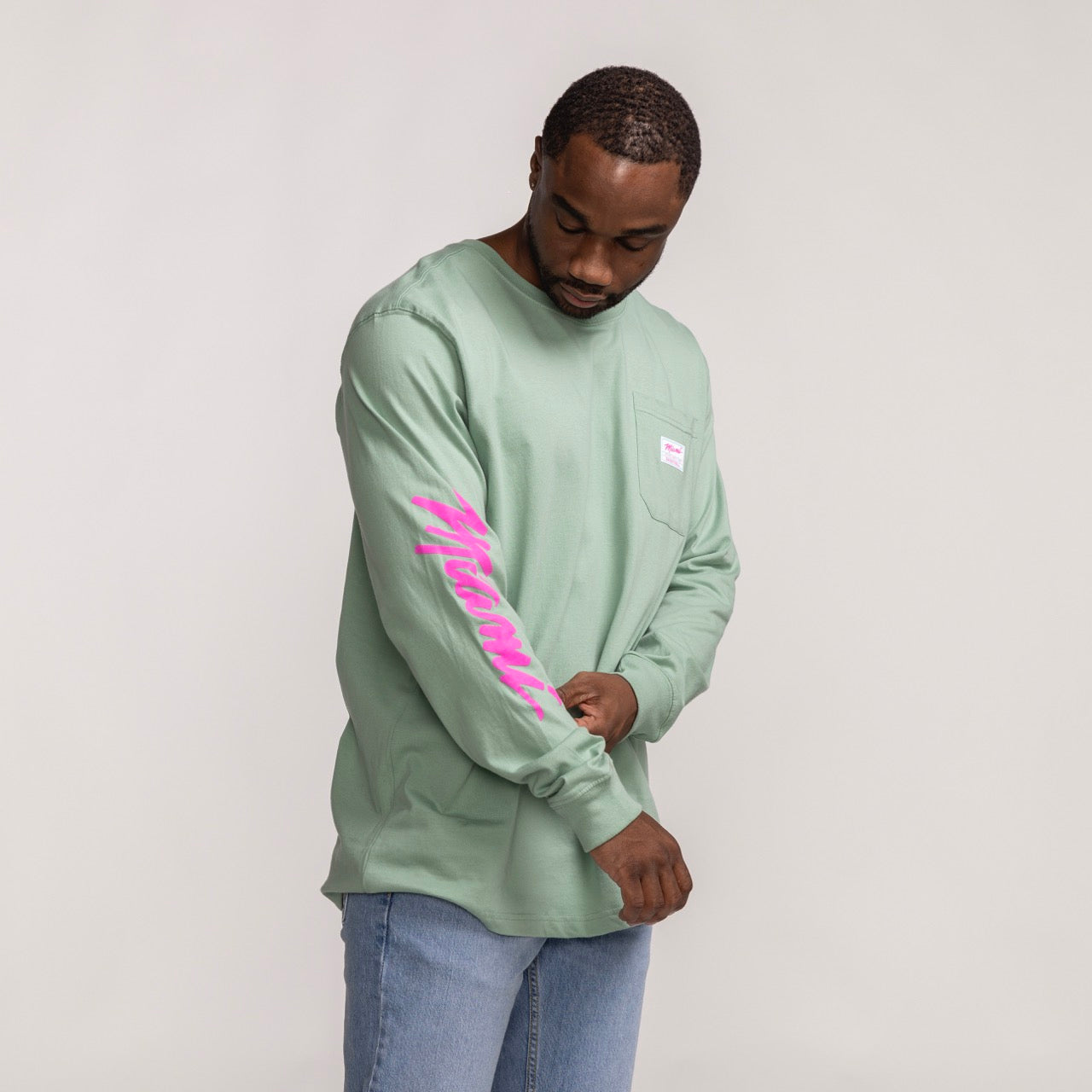 Mint green long sleeve tee with pink Miami HEAT Original Vice wordmark on sleeve and small chest logo. - Sportiqe Miami HEAT Original Vice Wordmark Long Sleeve Tee