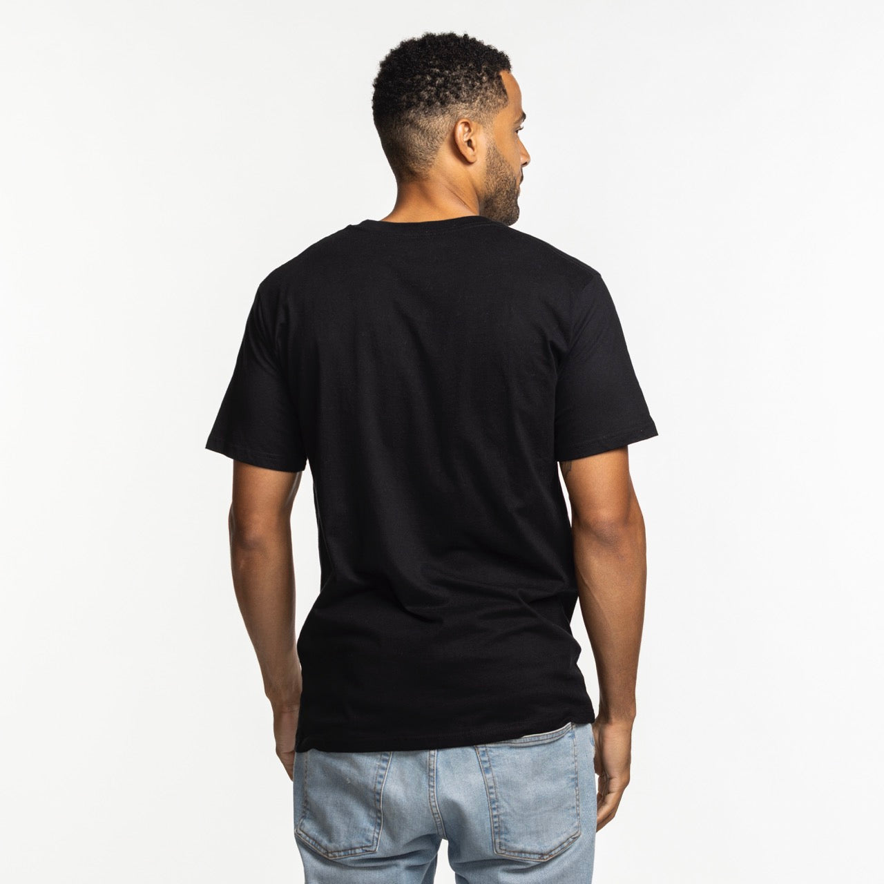 A man stands with his back to the camera, wearing a Court Culture 