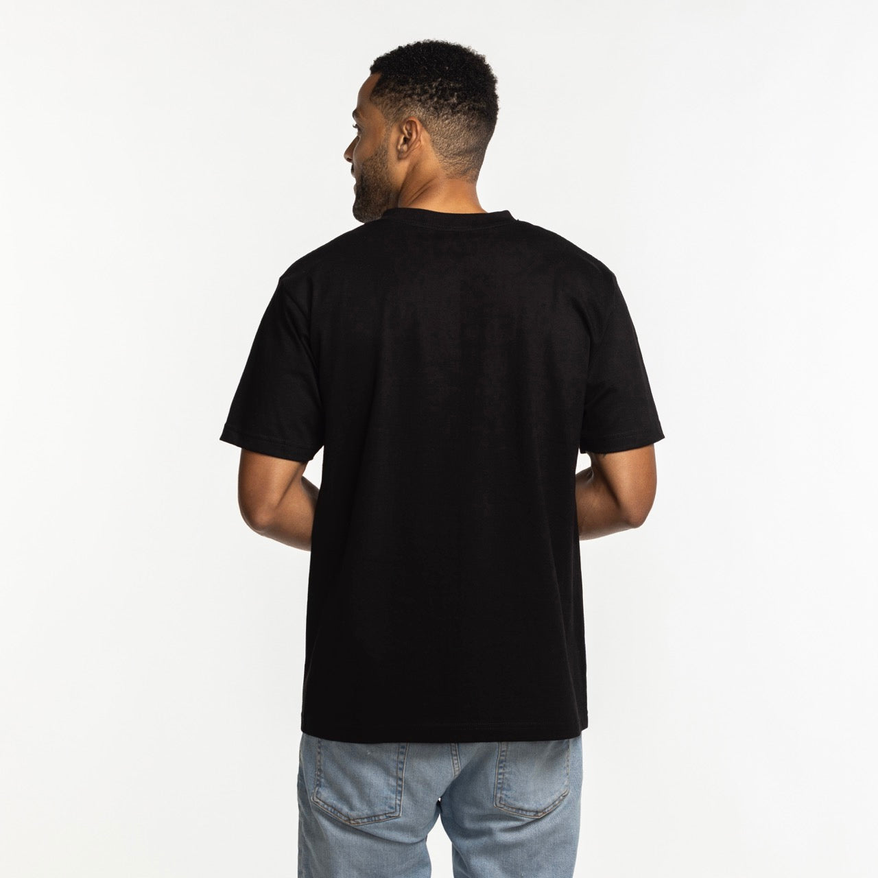 A man with short hair, seen from behind, wears the Court Culture x Mitchell & Ness 