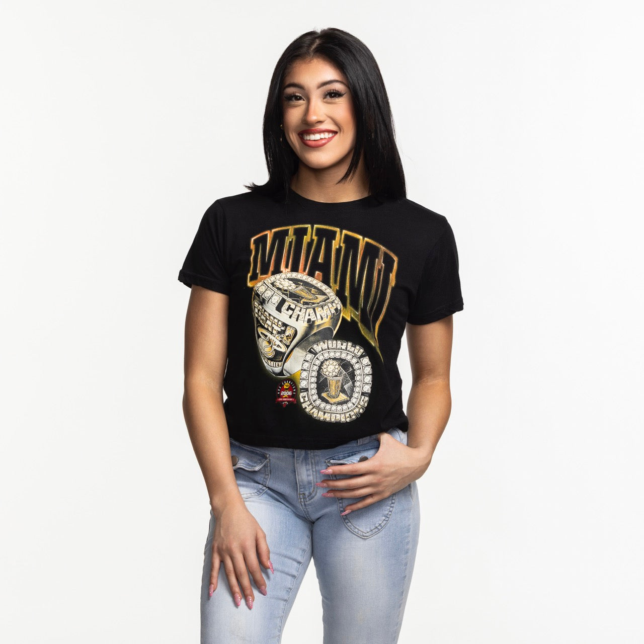 A woman with straight dark hair, smiling against a plain white background, wears a relaxed fit black Court Culture 