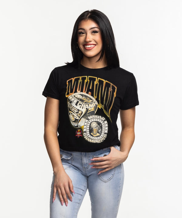 A woman with straight dark hair, smiling against a plain white background, wears a relaxed fit black Court Culture 