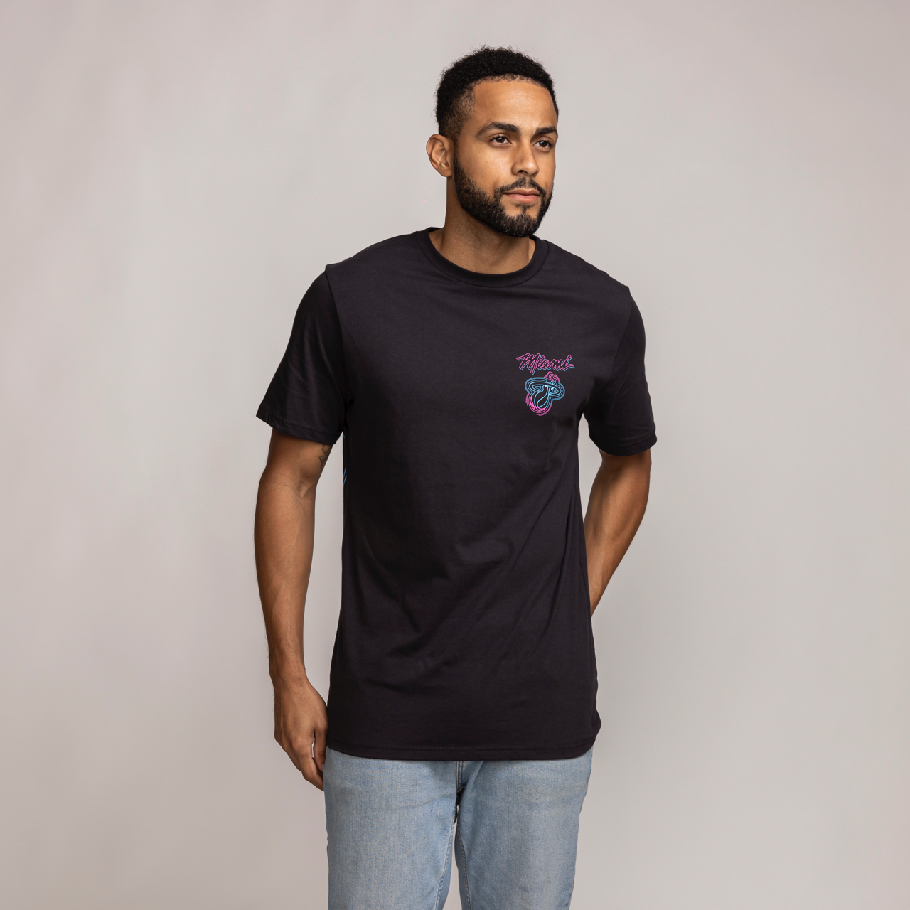 Black Miami HEAT Original Vice Venue short-sleeve tee with pink and blue logo on chest. - Stadium Essentials Miami HEAT Original Vice Venue Tee