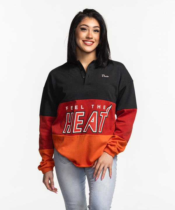 A man smiles in a relaxed fit Court Culture x Duvin Rugby Polo by Court Culture, featuring black, red, and orange pre-shrunk pique cotton with 