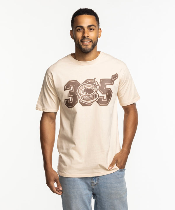A man in the Court Culture 305 Cafecito Unisex Tee—a beige, 100% cotton shirt with a coffee cup and 