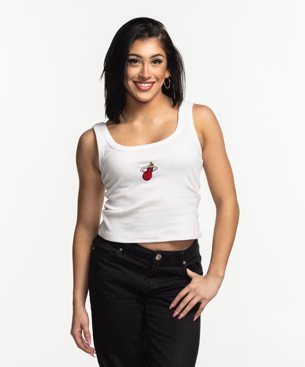 A smiling woman with straight dark hair wears the Court Culture Embroidered Logo Tank and black pants, standing against a plain white background.