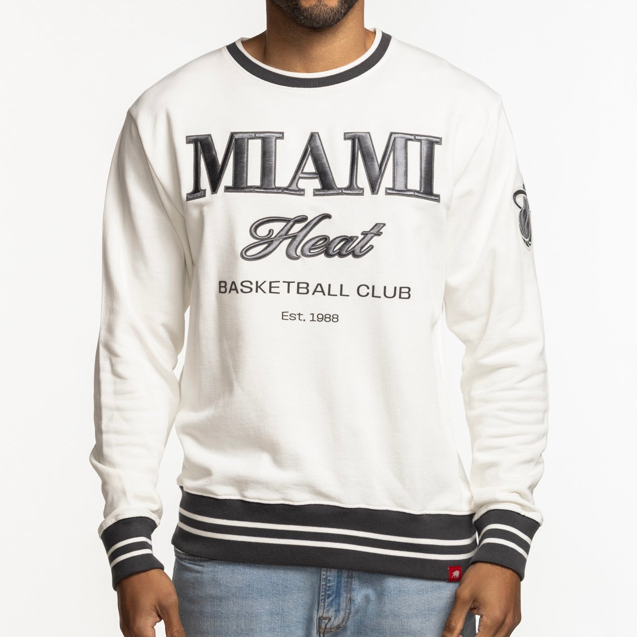 A person wears a Sportiqe Miami HEAT Basketball Club Crewneck by Sportiqe, standard fit, white with black and gray trim, and 