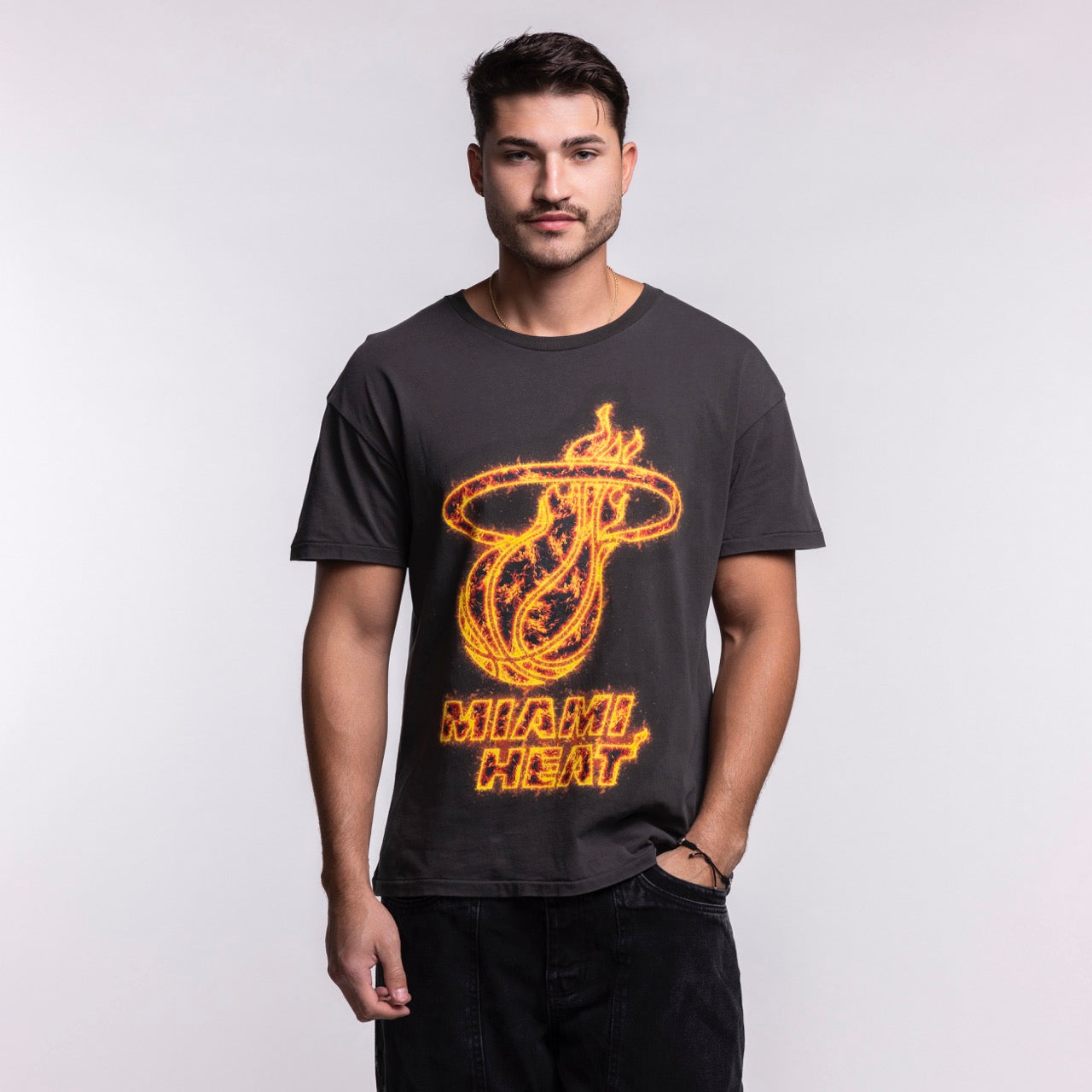 A man with short hair and a trimmed beard stands facing forward, wearing the Court Culture 