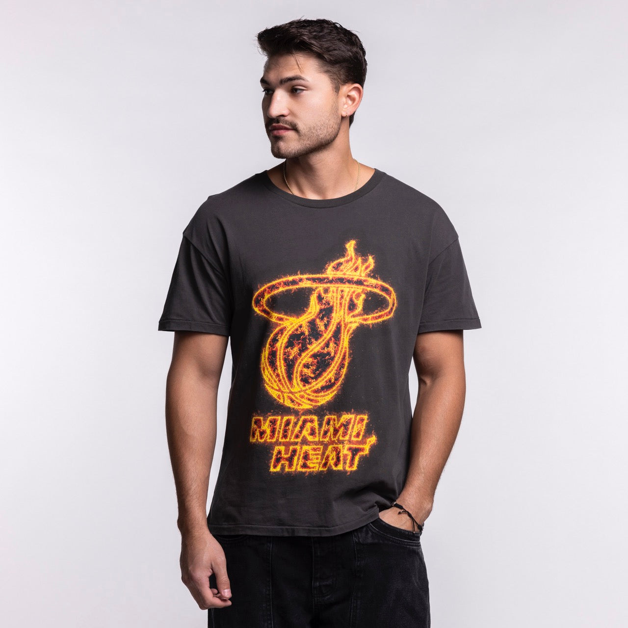 A man with short dark hair and facial hair wears the Court Culture 