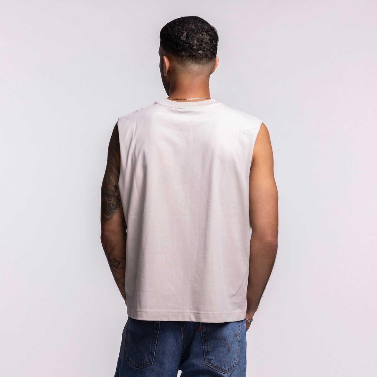 A person with short curly hair, facing away from the camera, wears the Court Culture 