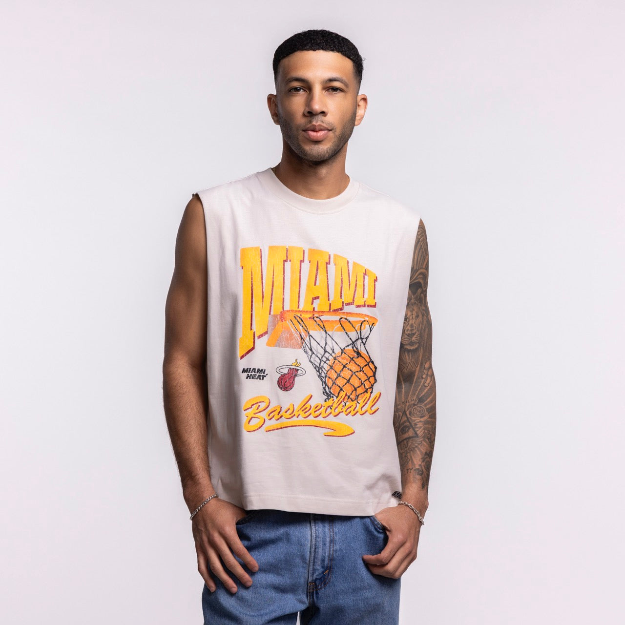 A man with short hair, a trimmed beard, and a left arm tattoo wears the Court Culture 