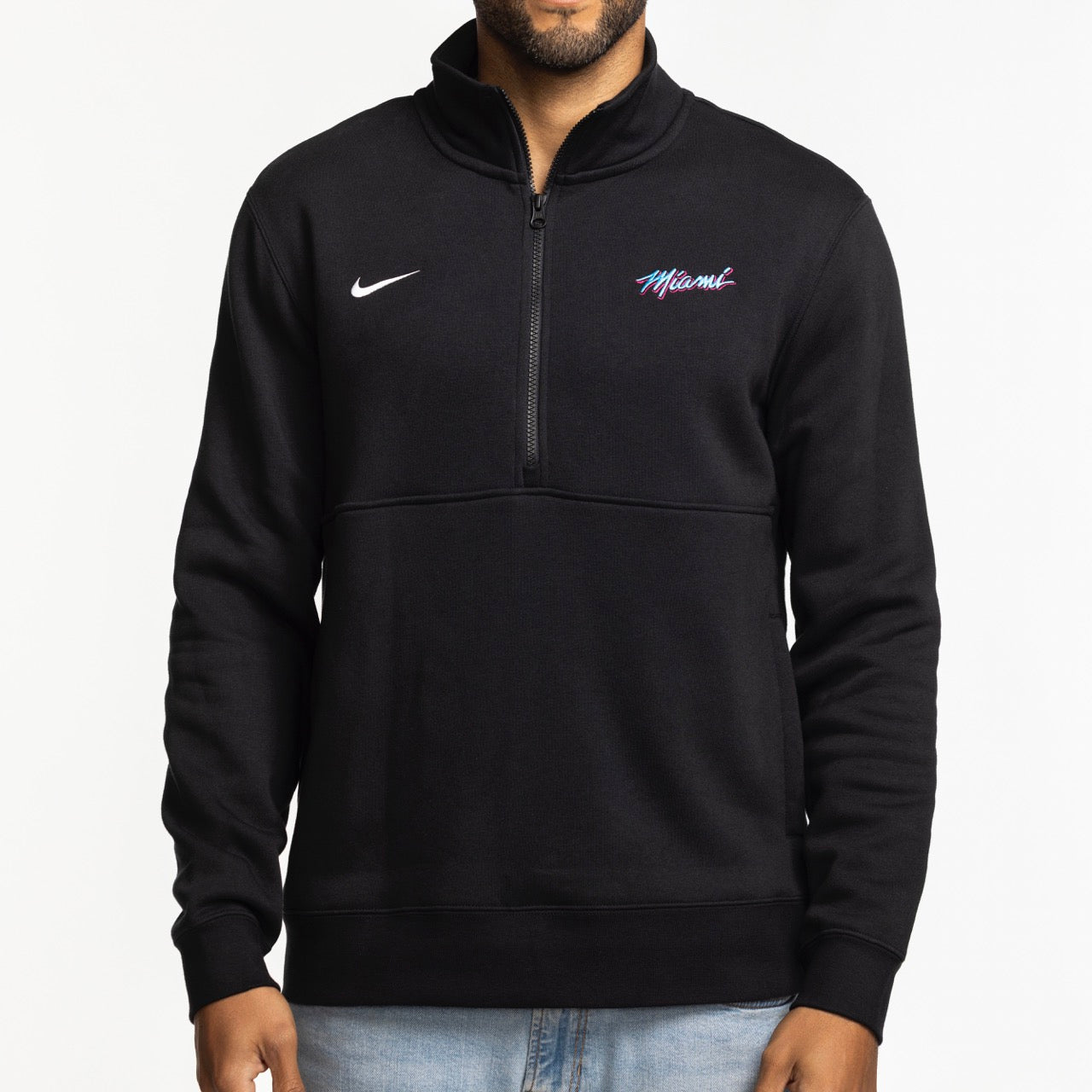 A person wears the Nike Miami HEAT Original Vice Nights 1/2 Zip Fleece Jacket, featuring colorful 