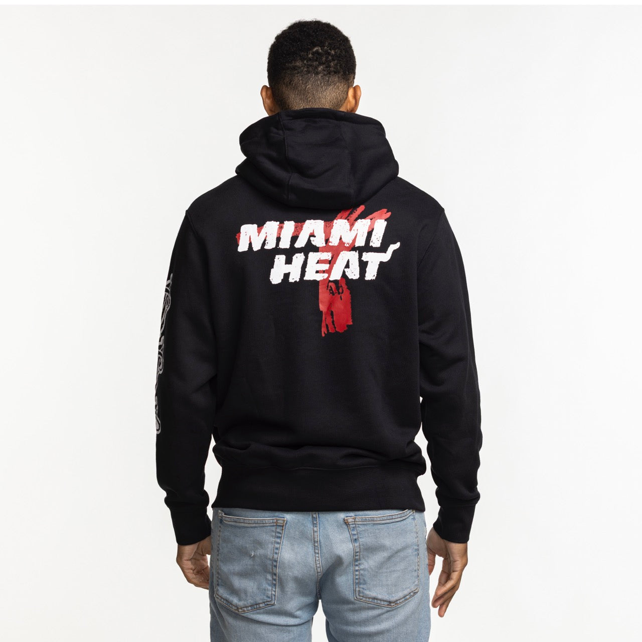 A person wears a Nike Miami HEAT Club Pullover Black Hoodie, featuring 