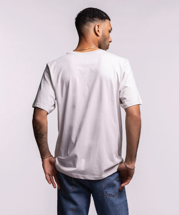 A man wearing the Sportiqe Miami HEAT 1988 Basketball Tee—white, standard fit, 100% cotton with 