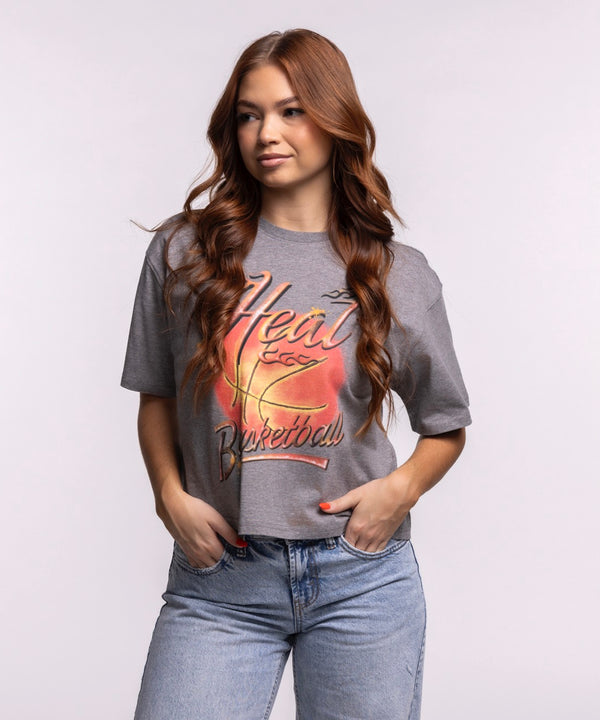 A woman with long, wavy auburn hair wears the Court Culture 