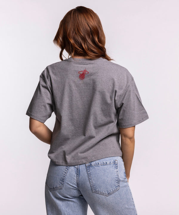 A woman with long, wavy auburn hair wears the Court Culture 