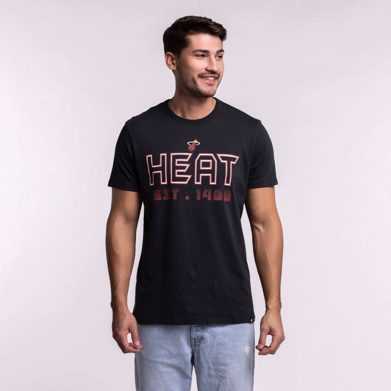 A man in a '47 Brand Miami HEAT Byline Franklin Tee, featuring bold red 