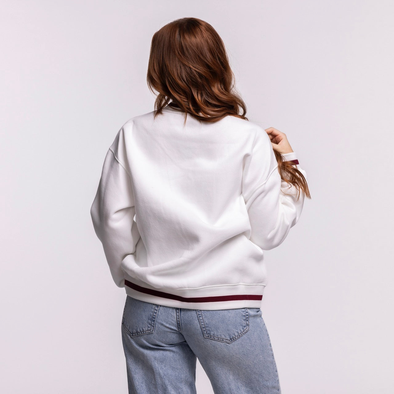 A person with long brown hair, wearing the Court Culture 