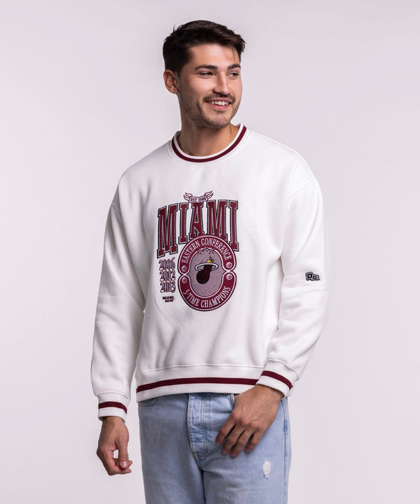 A man smiles against a plain light background wearing the Court Culture 