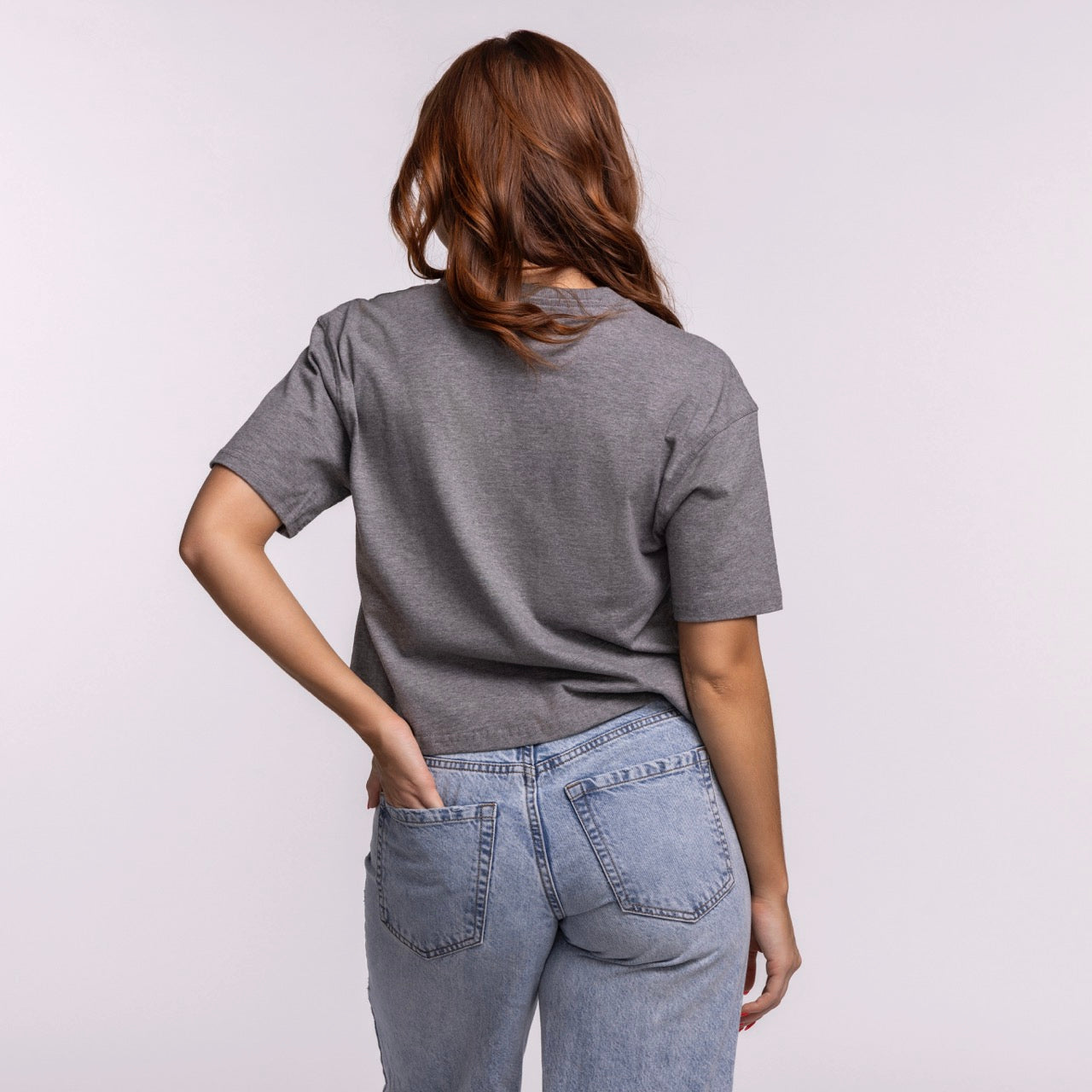 A person with long, wavy brown hair stands facing away, wearing the Court Culture Original Vice Nights 