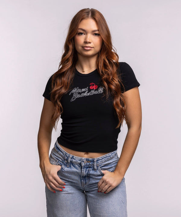 A young woman with long, wavy brown hair models the Court Culture 