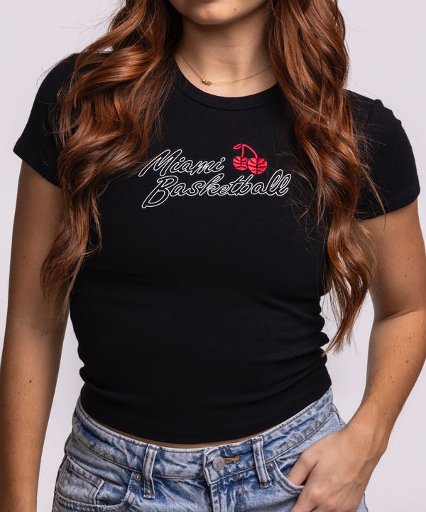 A young woman with long, wavy brown hair models the Court Culture 