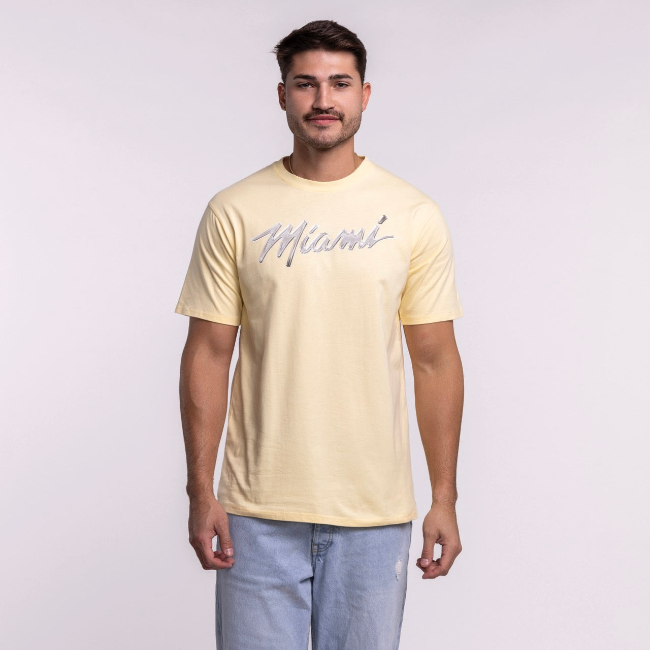 A man faces forward wearing a standard fit, light yellow Court Culture Original Vice Nights 